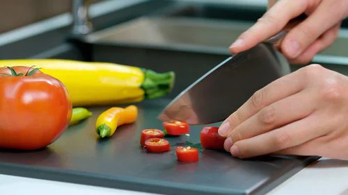 Nahaufnahme, wo Chilischoten geschnitten werden